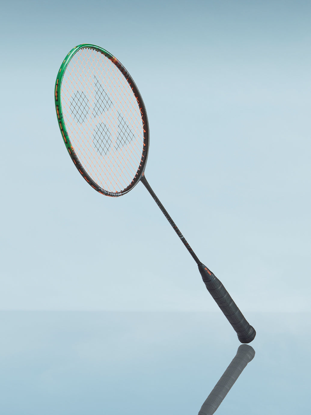 Badminton racket with a white string pattern on a light blue background